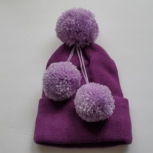 Purple knit hat with pom poms